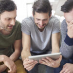 friends browsing photos from their old times